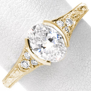Antique engagement ring in Rochester with oval center stone and scroll engraving.