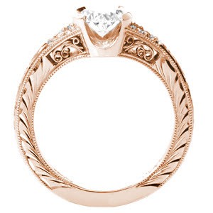Rose gold custom engagement ring in San Antonio with an oval cut center diamond held in a half bezel and bordered by beadset diamonds and hand engraving.