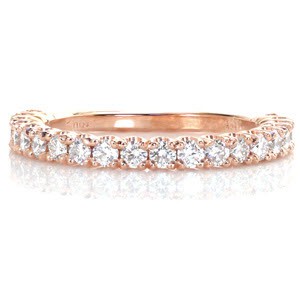 A versatile band of 14k rose gold, Design 3265 provides a perfect mate to any engagement ring or sparkling addition to a stacking ring collection.  Each diamond is set within individual four prong baskets which are hand formed. The unique U-Cut profile allows the maximum amount of light to enter the diamond.