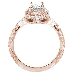Rose gold custom engagement ring in Memphis with a unique diamond halo surrounded a oval center diamond.