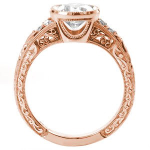 Rose gold custom engagement ring in Raleigh with a round brilliant center diamond held in a setting with unique filigree and hand engraving.