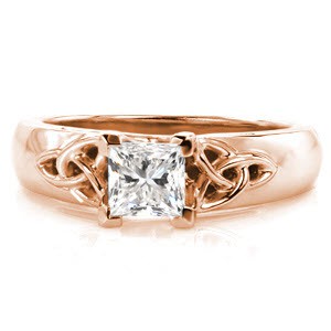 Let your heritage shine with this pristine example of Celtic design. A 0.70 carat princess cut center diamond is distinctively set within chevron prongs. Traditional Celtic knots with openwork frame flank the center diamond. The 14k white gold band has a wider look with rounded profile for a comfortable fit.