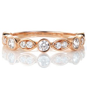Crafted in 14k rose gold, Lady Slipper is an elegant and contemporary band set with brilliant round cut diamonds.  Alternating shapes of marquise and rounds, the band has a soft scalloped outline. The high polish finish and low profile give this band a classic style.