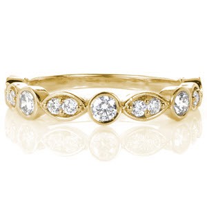 Victoria custom wedding ring with a unique band featuring alternating bezel set round diamonds and marquise shaped bead set diamonds.