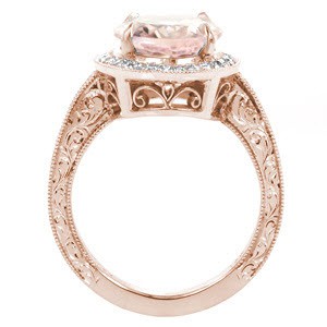 Antique inspired custom engagement ring in Detroit with an oval morganite center stone surrounded by a diamond halo and held in a hand engraved band.