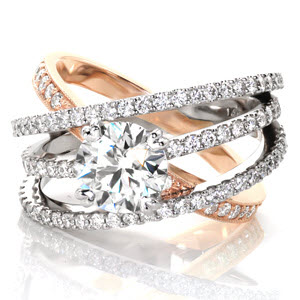 A signature look and statement piece, Design 3296 is a multiple band setting with a 1.50 carat round brilliant diamond. One bead set diamond band of 14k rose gold provides a subtle softness to the modern feel of the trio of 14k white gold diamond bands. The bands are joined at the bottom for a comfortable fit.