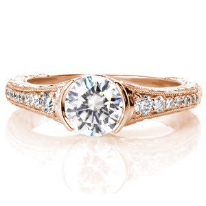 Custom rose gold engagement ring in Sacramento with a round center diamond held in a half bezel hand relief engraved setting.