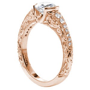 Antique rose gold engagement ring features intricate hand engraved designs. 