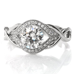 Featuring a 1.00 carat round brilliant cut center diamond, this elegant design has a unique, woven band. The loops of the ring form infinity signs to symbolize your endless love for each other. Dazzling side diamonds surround the center in a pulled halo. 