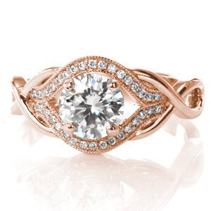 Featuring a 1.00 carat round brilliant cut center diamond, this elegant design has a unique, woven band. The loops of the ring form infinity signs to symbolize your endless love for each other. Dazzling side diamonds surround the center in a pulled halo. 