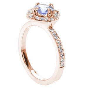 Custom antique inspired rose gold engagement ring in Sioux Falls featuring a round light blue sapphire held in a unique halo setting.