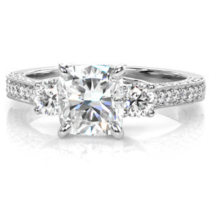 Atlanta three stone engagement ring with cushion cut center stone and round side stones.