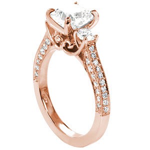 Custom rose gold three stone engagement ring with a cushion cut diamond center surrounded by beads set diamond and a floral profile design in Sacramento.