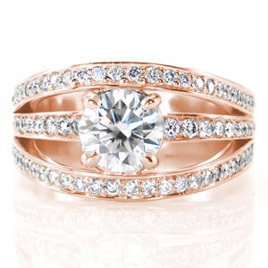 Design 3306 is set with a round brilliant cut center diamond within a unique floating four prongs basket. The wide euro shank band splits to create three bands which are decorated with round bead set diamonds. Crafted in 14k white gold, the two outermost bands are elevated to add dimension with a modern form.