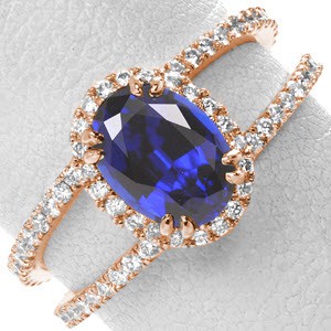 Rose gold engagement ring in Las Vegas with blue sapphire center stone, diamond band and split-shank band.