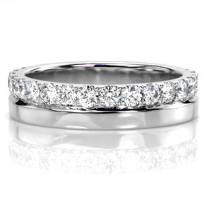 Unique diamond wedding band with round brilliant diamonds and 14k white gold metal.