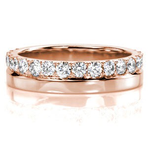 Design 3313 is a sophisticated wide band with the perfect amount of metropolitan styling.  Traditional jewelers techniques create this band of 14k white gold with 0.61 carats of round cut diamonds. Hand formed split prongs with a U-Cut profile emphasize the diamond sparkle.