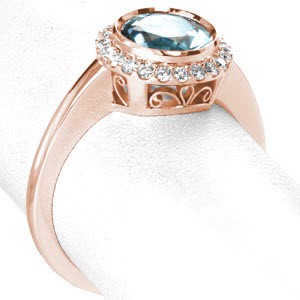 Portland filigree engagement ring with a full bezel aquamarine center gemstone and petite diamond halo.
