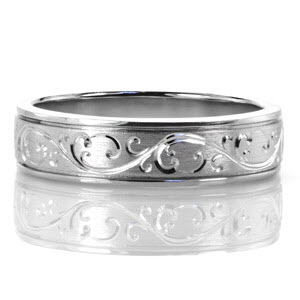 The Alpine Hand Engraved Scroll band features a crisp and distinctive hand engraved scroll pattern continuously around the band. A brushed finish accentuates the pattern by creating a slight contrast to the metal surface. The band is finished with two inward grooves and high polished outer rails.