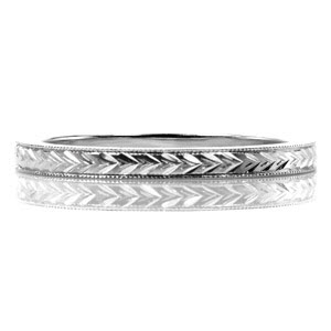 The Wheat Engraved 2.0mm band is a perfect example of incorporating crisp lines with a heirloom appeal.  Crafted in 14k white gold, the band measured 2.0mm wide. Hand formed double wheat engraving adorns the metal in an eternity style. Hand applied milgrain beading frames the stunning engraving.