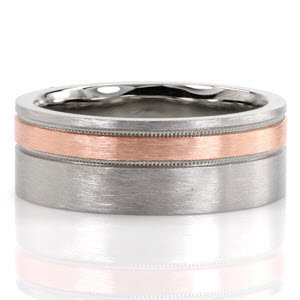 Design 3337 is a formalistic band created in precious 14 karat white gold.  A band of 14k rose gold is off center and finished with a reverse milgrain edging.  The hand applied brushed finish creates a distinguishable contrast between the two metal hues.