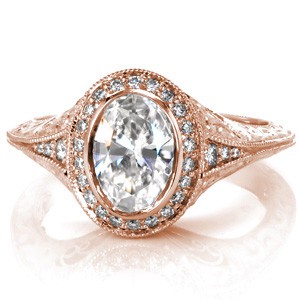 Custom engagement ring in Grand Rapids with a unique knife edge band and a diamond halo surrounding an oval center diamond.