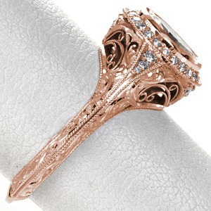 Custom rose gold engagement ring in Knoxville with a unique knife edge band and a diamond halo surrounding an oval center diamond.