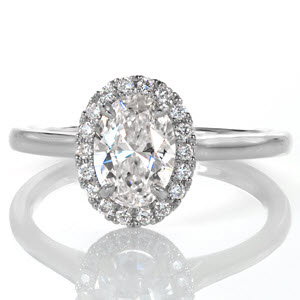 Halo engagement ring in Raleigh with small round diamonds and high polished band.