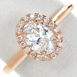 Houston rose gold wedding ring with diamond halo, high polished band and oval center stone.