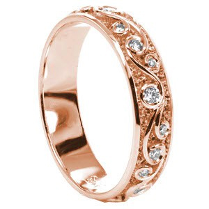 Custom rose gold wedding ring in Grand Rapids with a scroll pattern highlighted by bezel set diamonds.