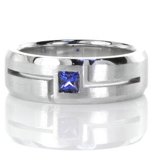 Modern lines and contrasting finishes highlight a natural blue sapphire in Design 3354. Crafted in 14k white gold, a square cut natural blue sapphire is outlined with bold open-cut grooves. The hand-applied brushed finish and high polish beveled edges bring balance to this wider band.