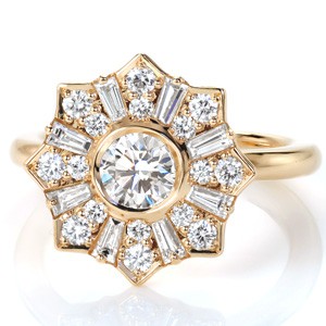 Antique halo style yellow gold engagement ring in Pittsburgh. The bezel set center diamond is surrounded by a starburst halo of baguettes and round diamonds. 