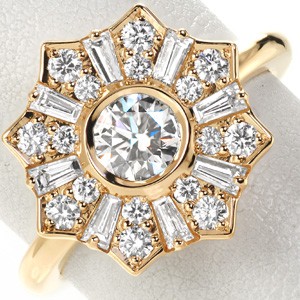 Yellow gold star halo engagement ring in Tampa, featuring tapered baguettes and a bezel set center diamond. 