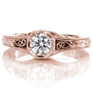 Rose gold custom engagement ring in St Petersburg with a round diamond held in a unique octagon setting with hand formed filigree and engraving.