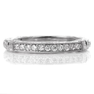 Design 3361 is the perfect companion to any antique inspired engagement ring. With equal measures of bead set diamonds, relief engraving, and hand engraving, this work-of-art band could even dazzle on your finger unaccompanied. Milgrain edges add the the final vintage inspired touch to this stunning design.