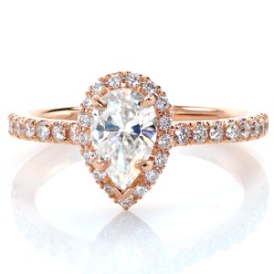 Antique pear engagement rings in Honolulu with a hand-set diamond band and halo. 