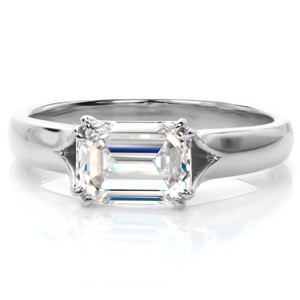 Madison custom solitaire engagement ring with a unique horizontal set emerald cut diamond center held by four double prongs.