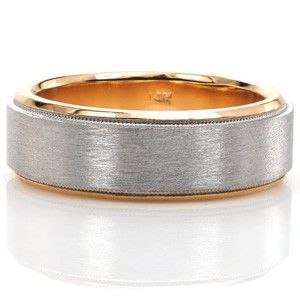 Our Denver, shown here in an updated 7 mm width, is one of our most versatile gentlemens custom wedding bands. Its high polished inner sleeve can be made in any warm toned gold, allowing for a modern two-tone look. The outside facing band is detailed with hand created milgrain and a subtle brushed finish.