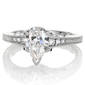 Pear cut diamond engagement ring in Raleigh with hand engraving and filigree.