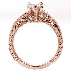 Rose gold custom engagement ring in Tampa with a unique pear cut center diamond held on a band featuring bead set diamonds and hand engraving.
