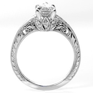 Vintage inspired custom engagement ring in Nashville with a unique pear cut center diamond held on a band featuring bead set diamonds and hand engraving.