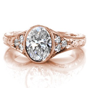 Vintage rose gold oval engagement rings in Chicago with milgrain and filigree. This beautiful design features antique inspired details such as hand engraving, filigree, and a bezel setting for the center stone.