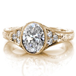 Fargo antique inspired custom engagement  ring with a bezel set oval center diamond and a hand engraved band.