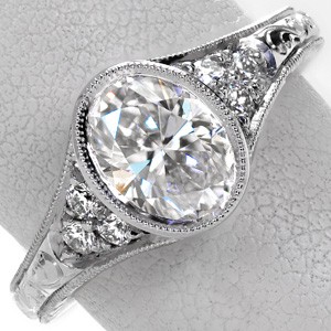 Custom engagement ring in Dallas with bezel set oval center stone and antique details.
