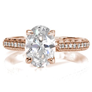Rose gold custom engagement ring in Dallas with a hand engraved band, marquise surprise stone and oval center diamond.