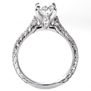 Vintage inspired custom engagement ring in Grad Rapids with a hand engraved band, marquise surprise stone and oval center diamond.