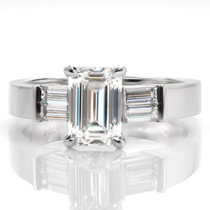 Design 3389 is elegantly detailed with a pair of baguette cut diamonds on each side of the center stone. The step-cut facets of the emerald cut is mirrored in the surrounding baguettes. The lustrous 14k white gold is the perfect transition from the shine of the smooth metal to brilliant diamonds.