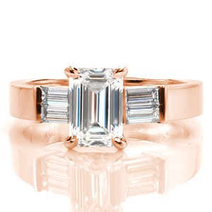 Design 3389 is elegantly detailed with a pair of baguette cut diamonds on each side of the center stone. The step-cut facets of the emerald cut is mirrored in the surrounding baguettes. The lustrous 14k white gold is the perfect transition from the shine of the smooth metal to brilliant diamonds.