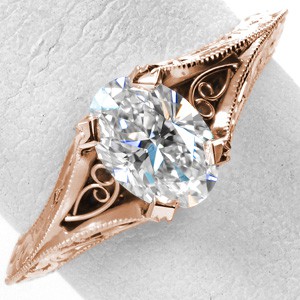 Rose gold engagement ring in Oakland with oval center stone, milgrain texture and scroll filigree.