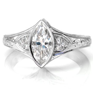 Antique inspired custom engagement ring in Hartford with a unique marquise center diamond set in a bezel setting.